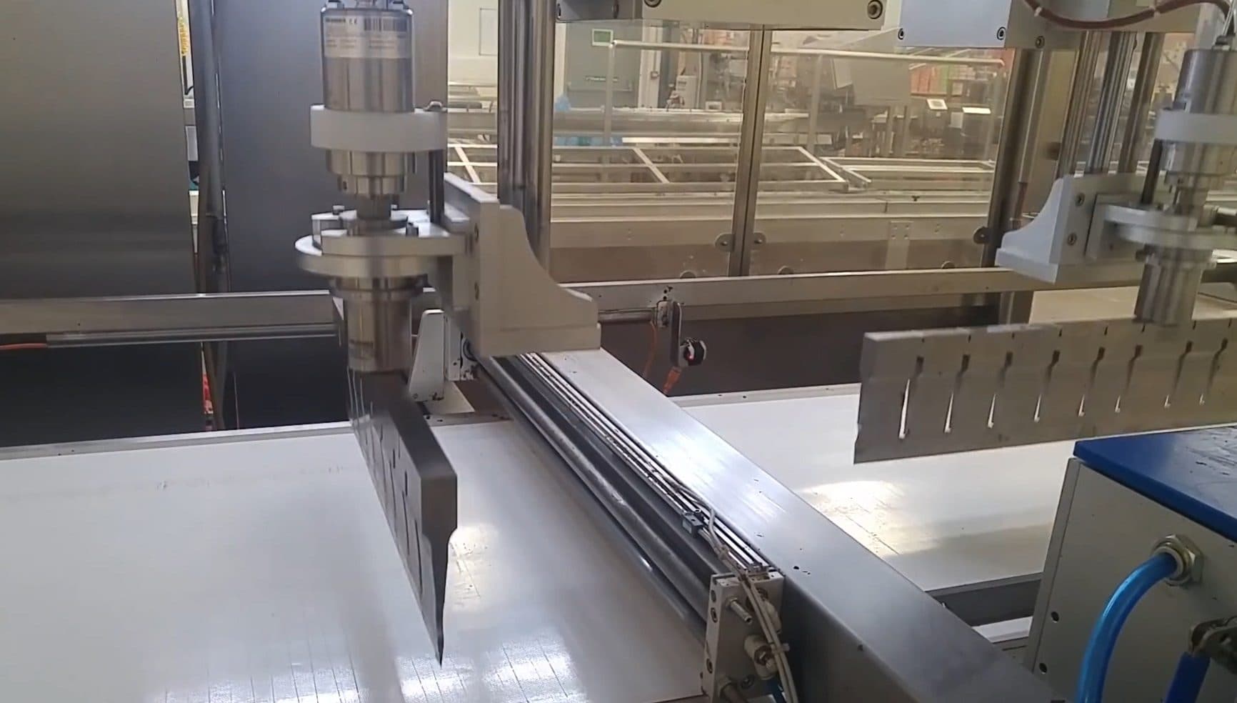 Twin ultrasonic blades positioned over the cutting belt of a bakery machine